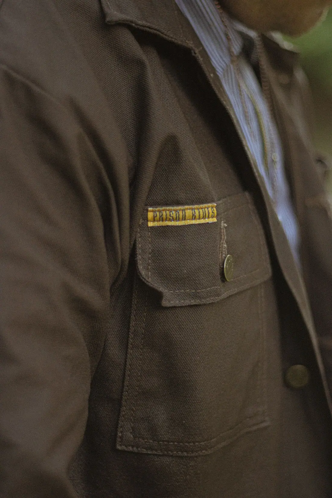 Close detail of a waxed-cotton work jacket chest pocket.